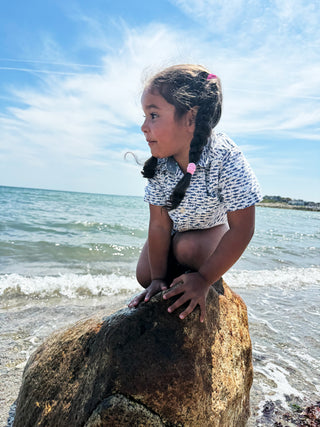 Girl looking over the ocean in Scituate MA